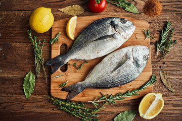 sea fish fresh ingredients lemon on wooden board