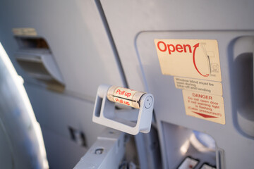 Emergency exit door on an aircraft,View from inside of the plane, emergency pull up