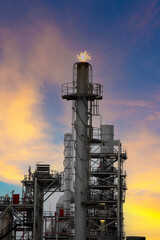 Oil refinery plant chemical factory and power plant with many storage tanks and pipelines at sunset