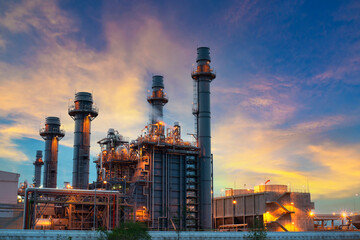 Oil refinery plant chemical factory and power plant with many storage tanks and pipelines at sunset