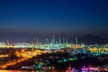 Fototapeta na wymiar Oil refinery plant chemical factory and power plant with many storage tanks and pipelines at sunset