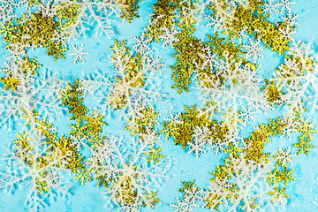 christmas blue background with white and gold large and small snowflakes