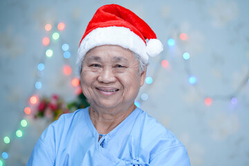 Asian senior or elderly old lady woman patient with Santa Claus helper hat in Christmas and new...