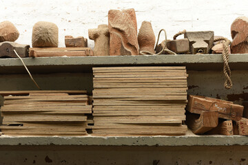 Wood for carving pieces on a shelf in the carpentry workshop. Carpenter workplace. Close-up,...