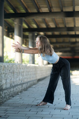 The girl dances beautifully under the bridge