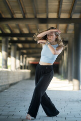 The girl dances beautifully under the bridge