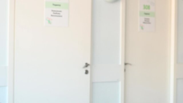 blurred image a nurse in a white coat in a polyclinic enters the office. High quality 4k footage