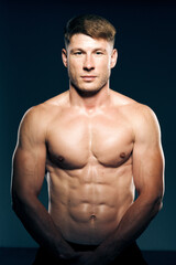 Fototapeta premium athletic male topless workout muscle bodybuilder dark background