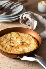Frying pan with Tortilla, Spanish omelette made with eggs and potatoes.