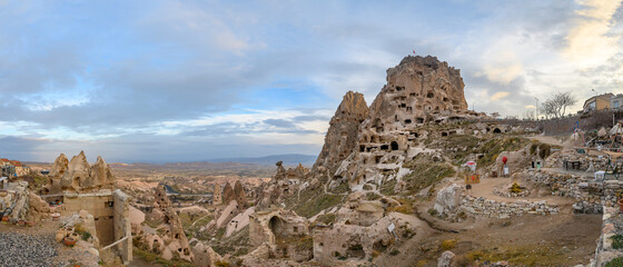 Uchisar Castle, town in Cappadocia, Turkey near Goreme. Panorama of Cappadocia landscape and valley with ancient rock formation and caves.