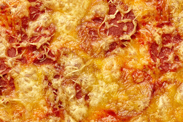 Obraz na płótnie Canvas Closeup of browned cheese crust covering soy sausage slices on vegan pizza