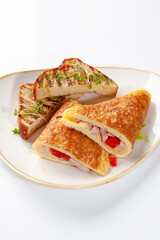 Fluffy omelette with ham, cheese and tomatoes served with toasted bread