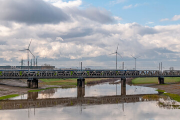 The Arno drain in the industrial area of Pontedera, Pisa, Italy, under a dramatic sky