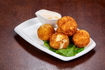 Fried cheese balls with sauce
