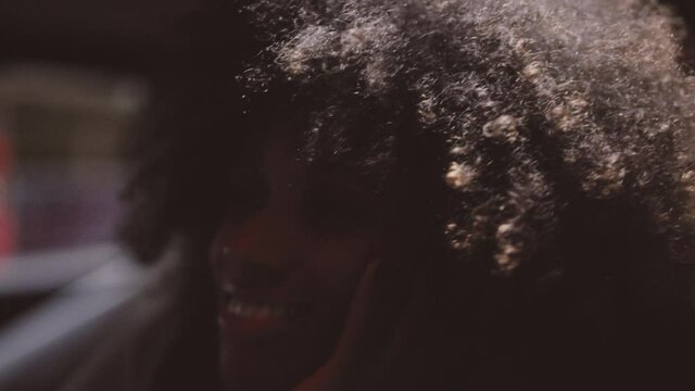 Smiling Woman With Afro Hair In Ferrari