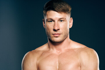 Fototapeta premium athletic male topless workout muscle bodybuilder dark background