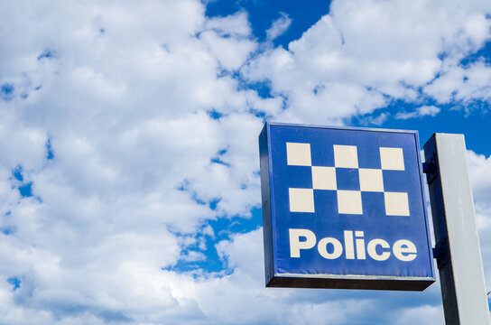New South wales police station sign with cloudy sky at the background.