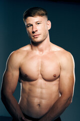 Fototapeta na wymiar athletic male topless workout muscle bodybuilder dark background