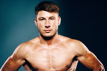 Fototapeta premium athletic male topless workout muscle bodybuilder dark background