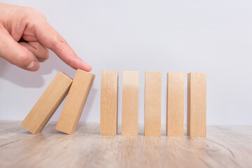 hand stops and protects the fall of a wooden block, risk protection concept