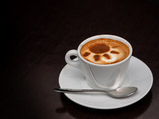 Coffee latte art in white coffee cup on dark table background and copy space