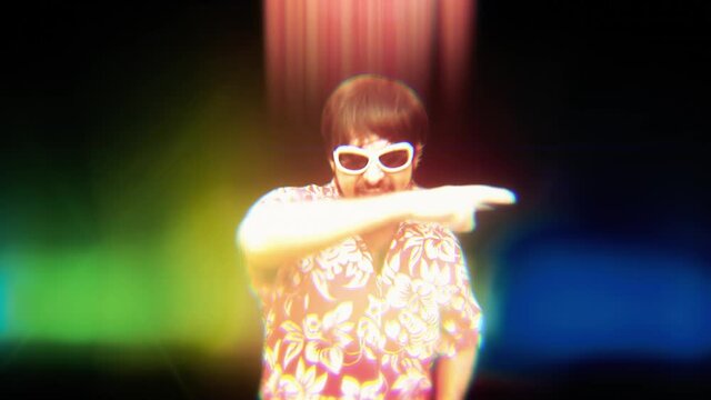 Slow motion: a funny silly DJ dancing with lights, maybe on an acid trip. Medium shot.
