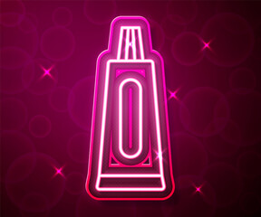 Glowing neon line Tube of toothpaste icon isolated on red background. Vector