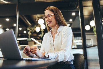 Happy young businesswoman taking a video call