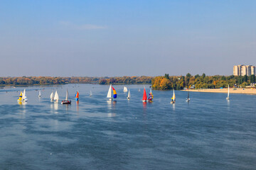 Fototapeta na wymiar Yachts at sailing regatta on the Dnieper river in Kremenchug, Ukraine