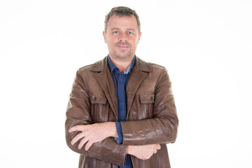 handsome man posing with arms folded in leather jacket middle aged portrait concept on white background