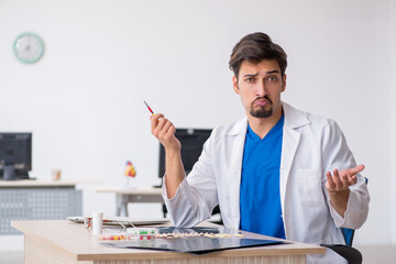 Young male doctor working in the clinic