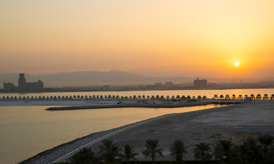 Sunrise in yellow tones over Marjan Island in emirate of Ras al Khaimah, a perfect getaway destination in the United Arab Emirates.