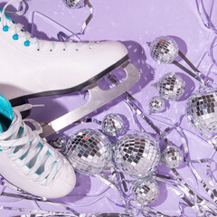 Christmas creative layout with ice skates ,disco balls decoration and silver foil fringe curtain on...