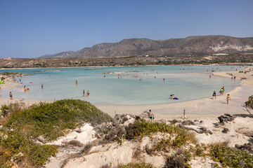 People relaxing on the famous pink coral beach of Elafonisi on Crete, Mediterannean sea, Greece