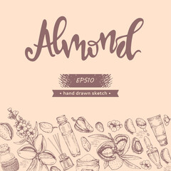 Background with almond, essential oils, flowers and lettering almond
