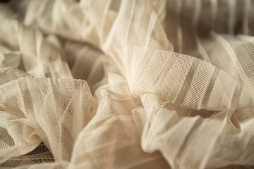 Draped beige colored tulle textile background