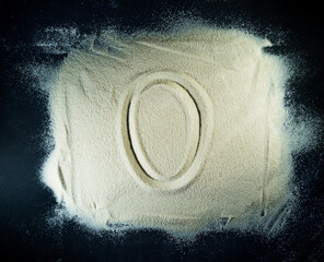 Greek letter omicron written on the white sand with black background