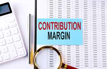 CONTRIBUTION MARGIN on sticker on chart background, business concept