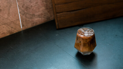 iced coffee with milk  served on the black table at a cafe​