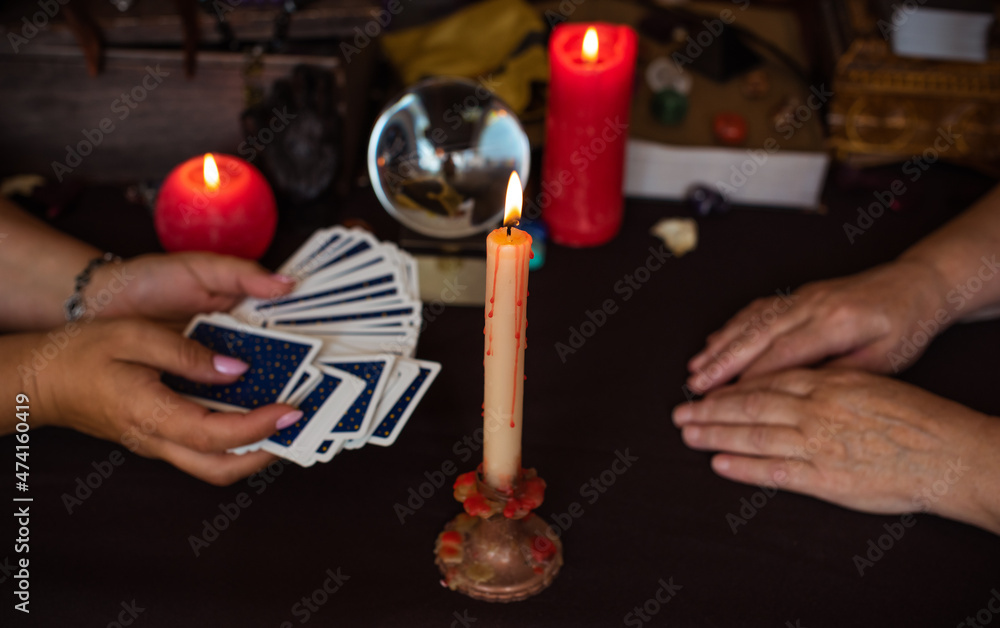 Wall mural Altar of wicca, candle, magic books, tarot cards and other witch stuff. Mystic background with ritual esoteric objects, occult, fortune telling and Halloween concept