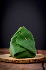 Banana leaves for wrapping food and fixing with small pointed sticks. natural food packaging. Using...