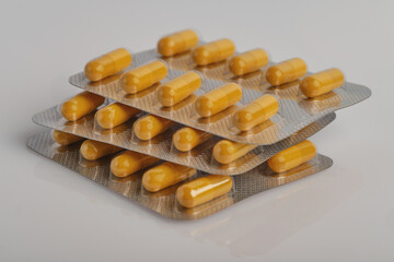 orange capsules with medicine on the table