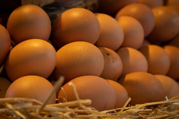 Some brown eggs with straws in the market