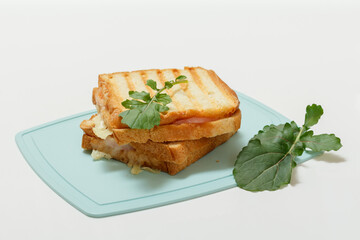 Homemade grilled cheese sandwich for breakfast on cutting board.