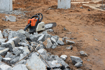 Chainsaw at construction site for foundation
