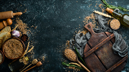 Fototapeta na wymiar Culinary background: flour, rye, wheat, kitchen utensils. Baking. Top view. Rustic style.
