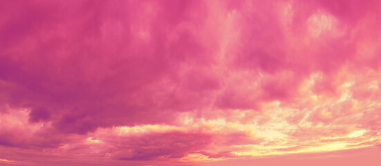 Panorama of a pink cloudy sky at sunset. Sky texture. Abstract nature background