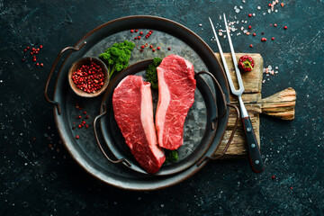 Raw fresh marble meat Black Angus Steak Ribeye on a dark background. Top view. Raw meat.
