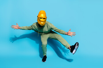 Photo of freak weird funky entertainer dance wear gorilla mask sportswear footwear isolated blue...