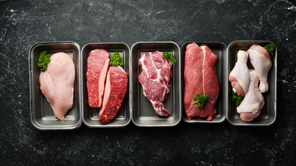 Set of fresh raw meat: veal, chicken, pork. On a black stone background. Organic food.